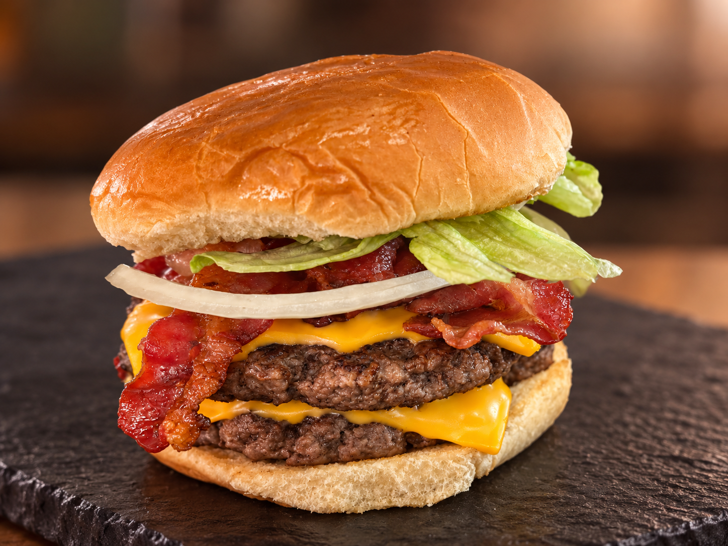 Double burger with bacon, cheese, lettuce, and onions